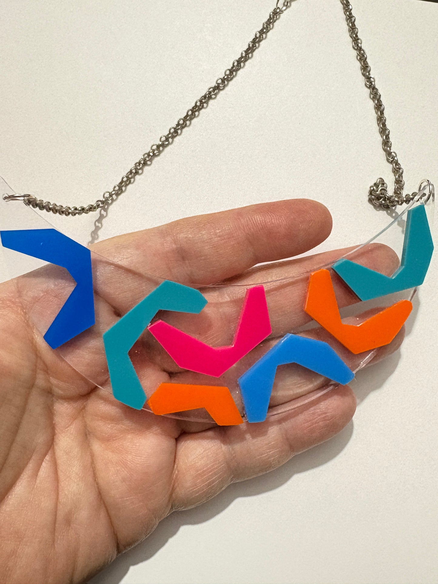 Close up of colorful retro 80s She Bop necklace from Audacious Studio.