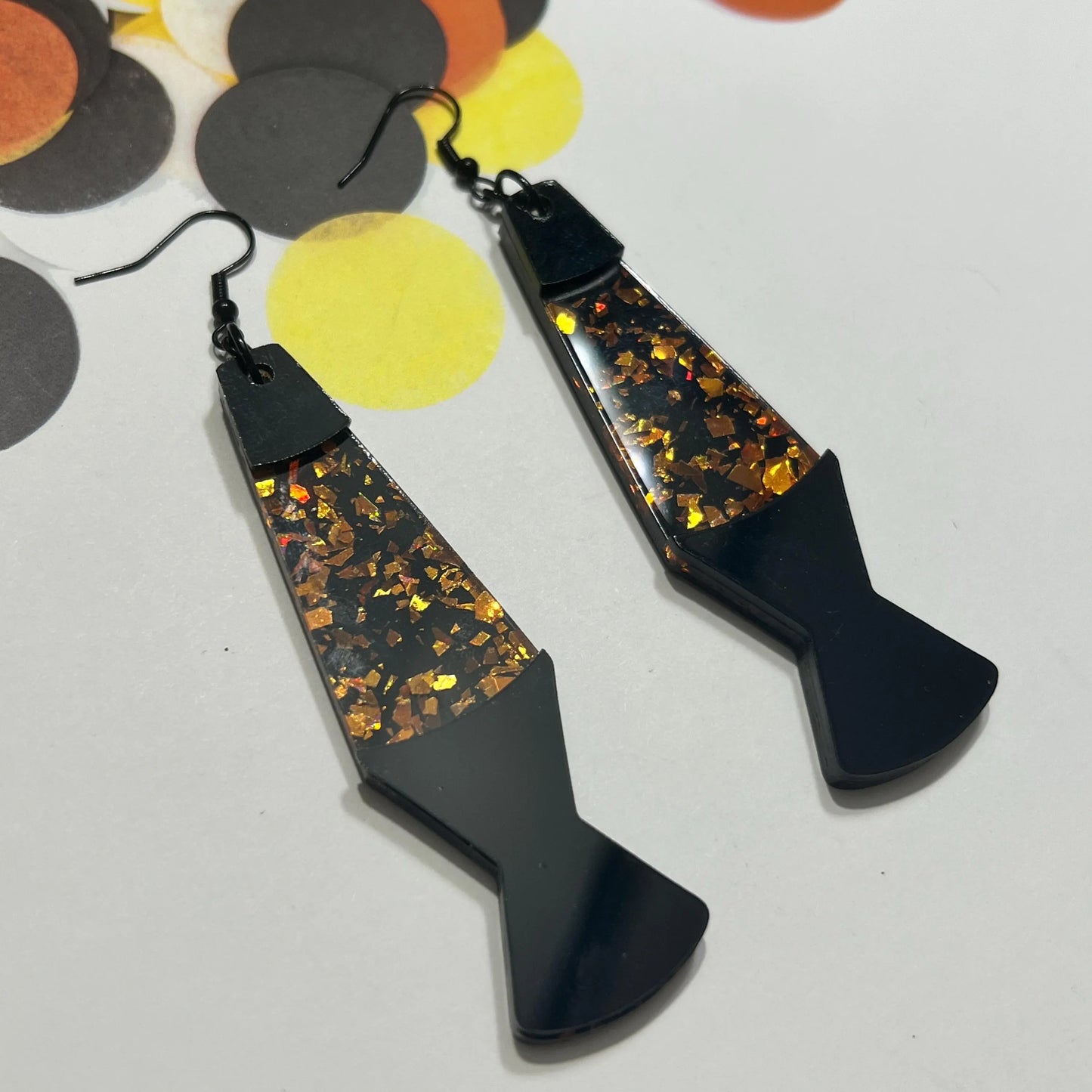 Large black and holographic orange acrylic lava lamp earrings from by Barbe Jewelry.
