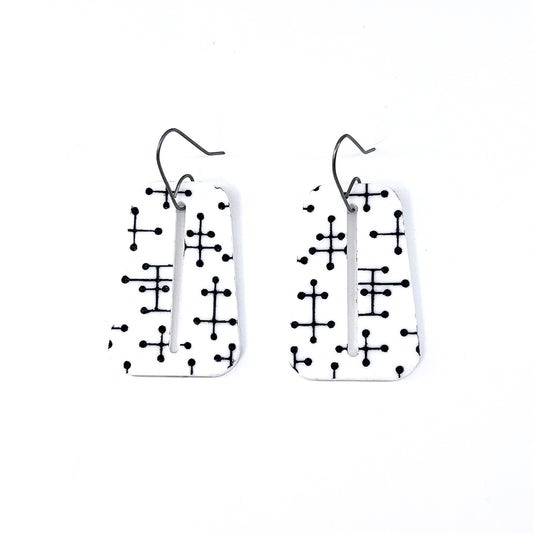 White trapezoid Eames inspired Pin Dot etched acrylic earrings on white background.