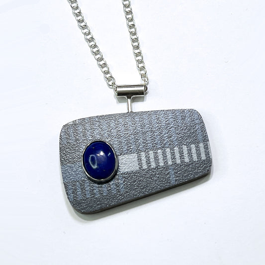 Recycled formica laminate in blue with a blue sodalite stone necklace.
