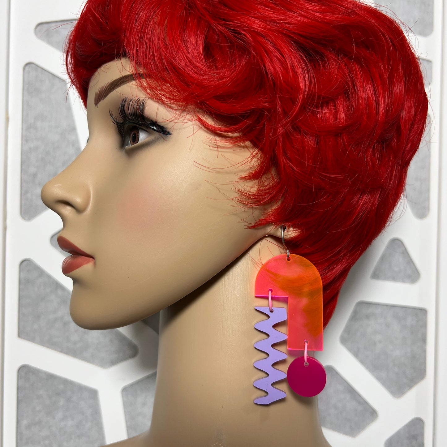 Mannequin wearing Neon Arch Mobile earrings from Audacious Studio. 