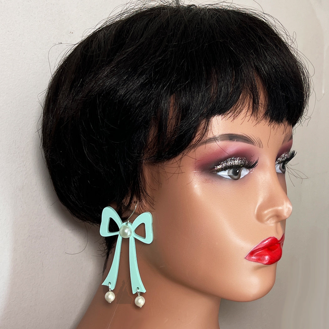 Large aqua acrylic bow earrings on mannequin head.