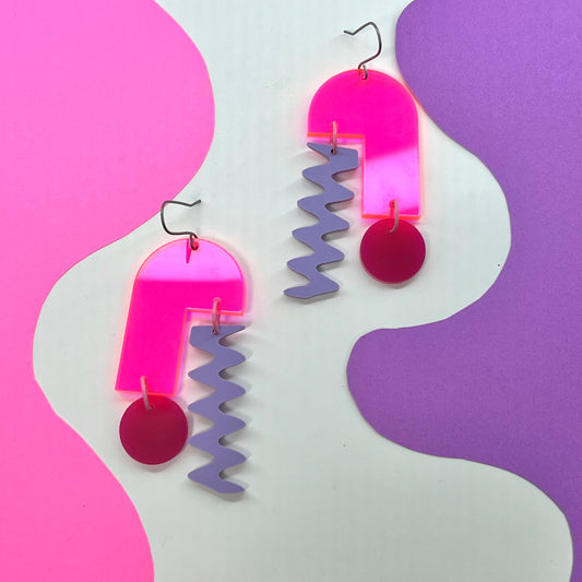 Retro mobile earrings in neon hot pink, magenta and lilac on white, pink and purple background. 