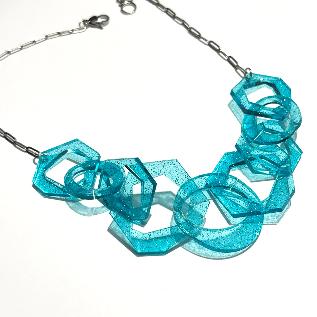 Turquoise Glitter abstract geometric necklace on a white background