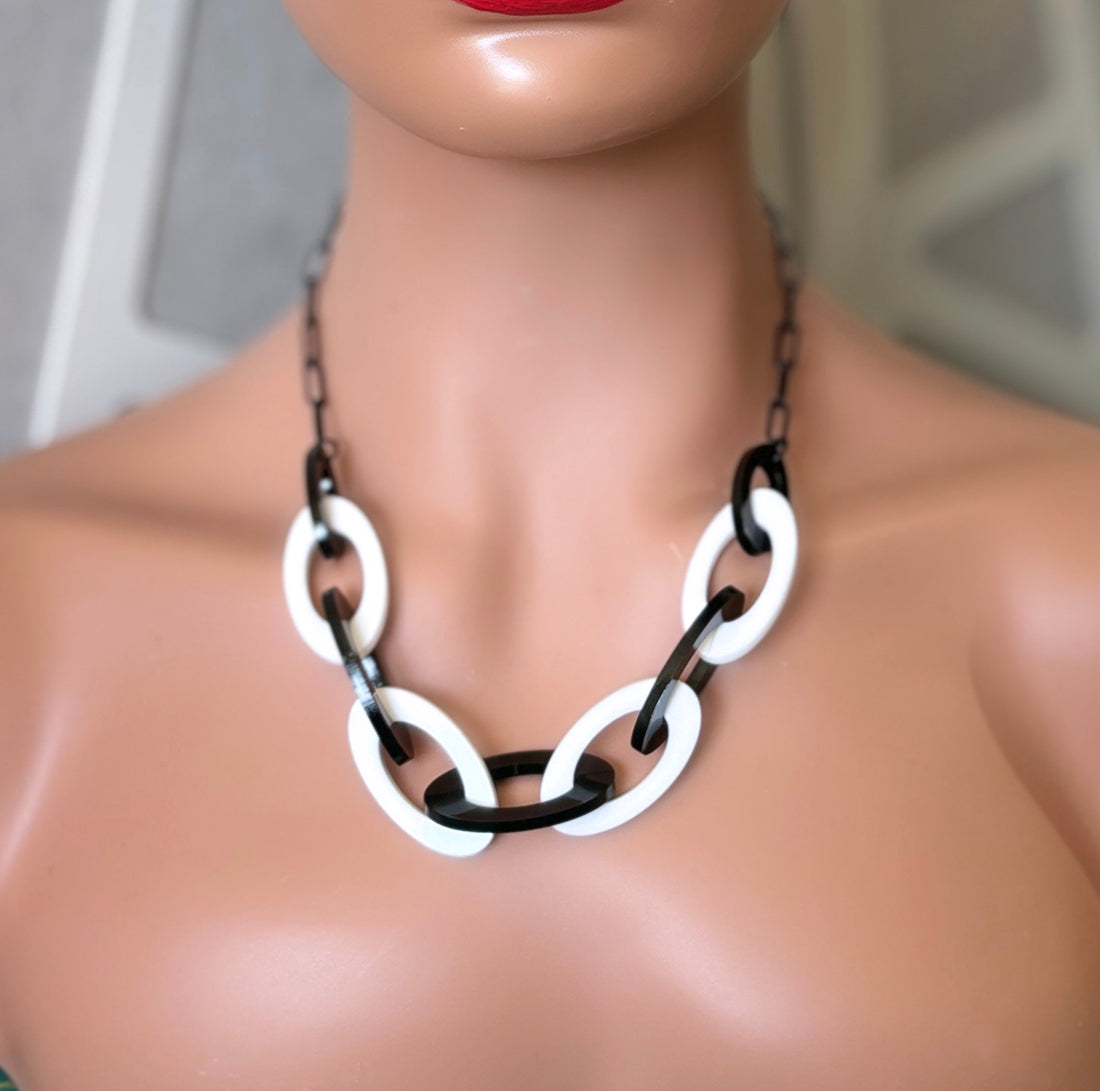 Mannequin wearing a black and white acrylic chain statement necklace