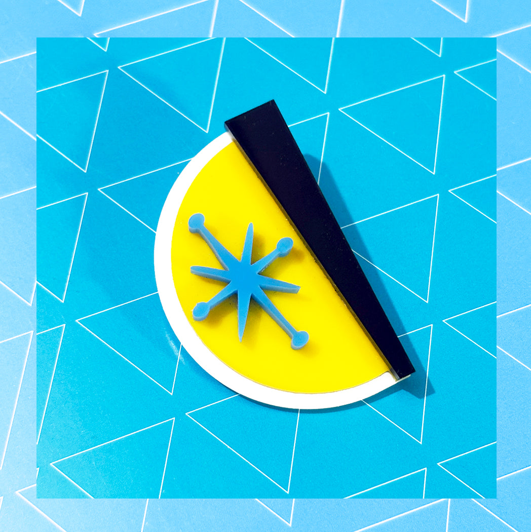 Jetson's style blue starburst atomic brooch.
