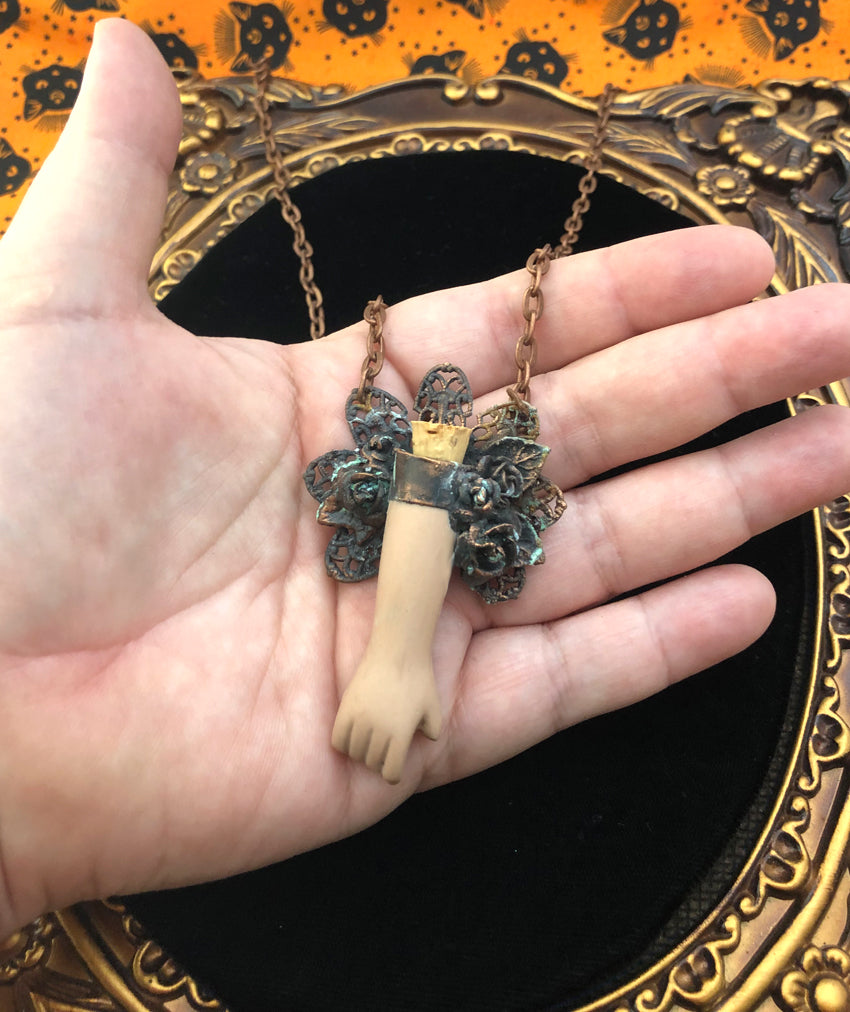 Floral Doll Arm Reliquary Pendant