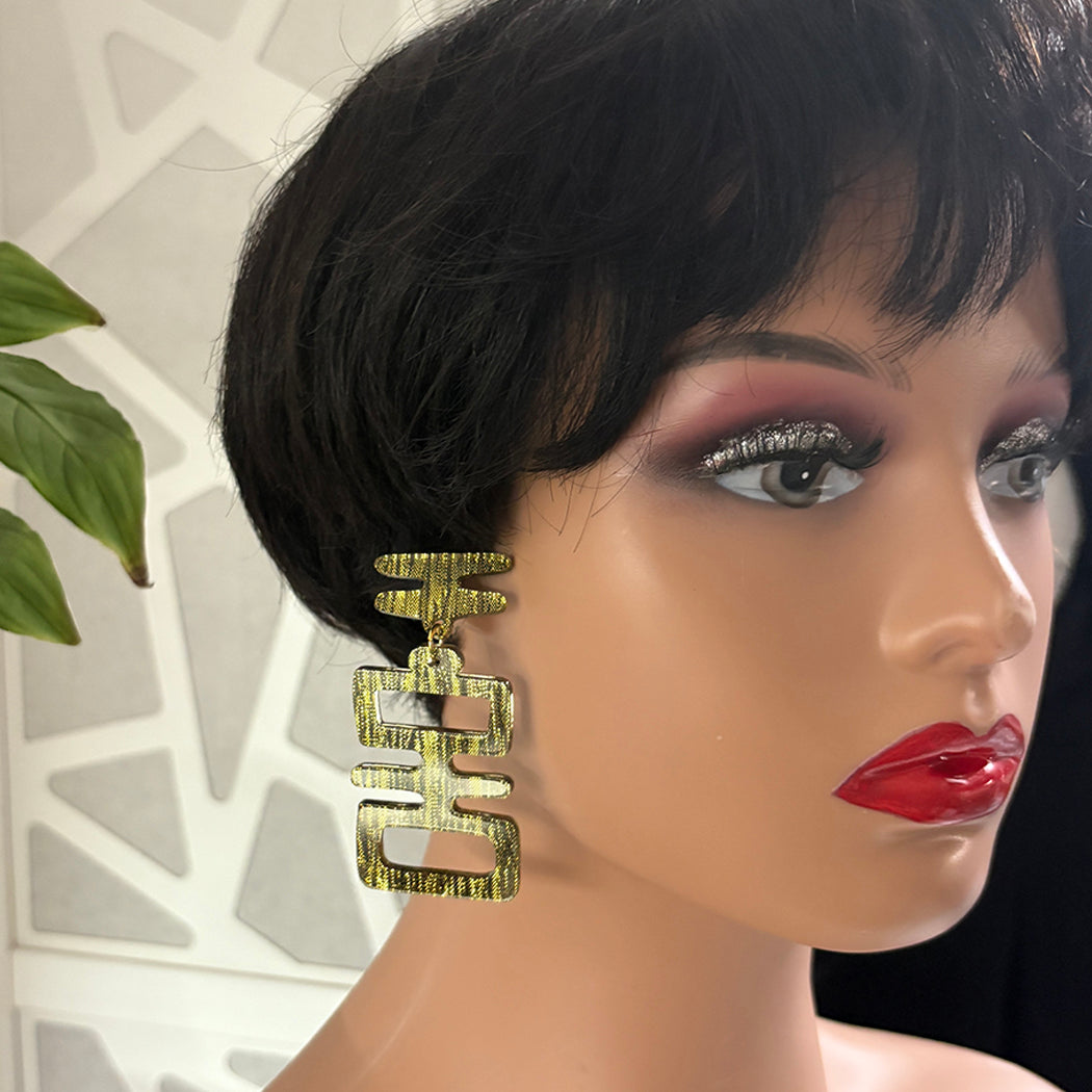 Mannequin wearing Golden Idol tiki style earrings.
