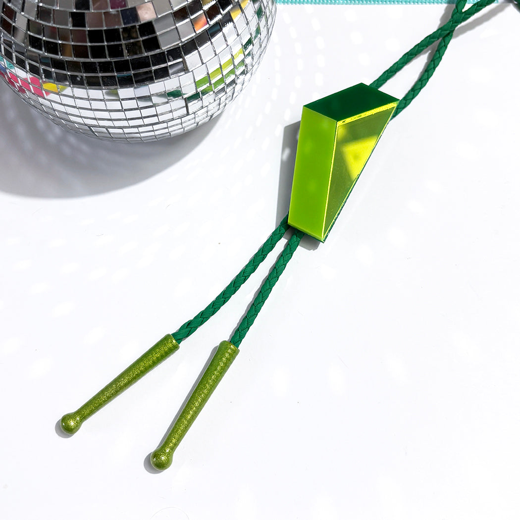 Vibrant green Vernor Vector bolo tie on white background with disco ball. 
