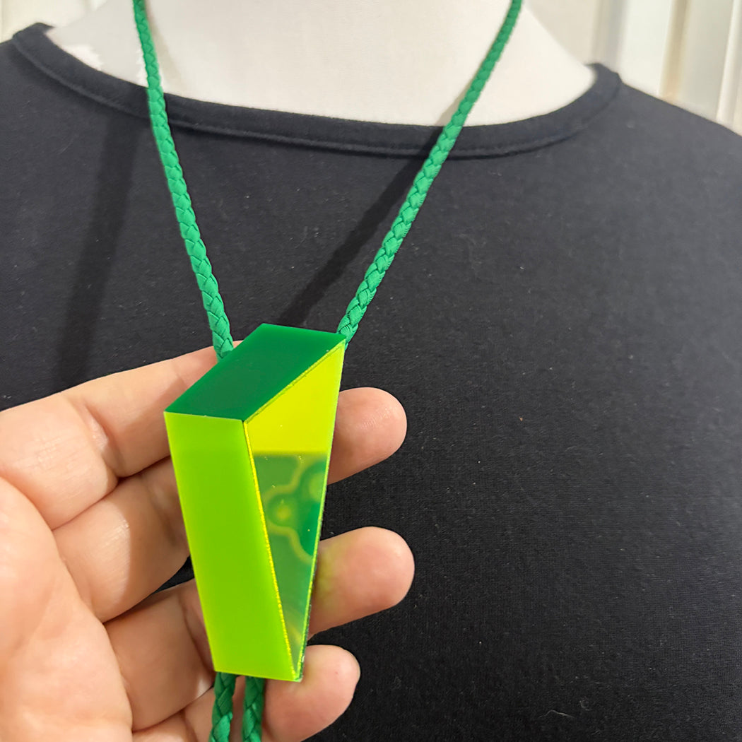 Detail of lime mirror, lime green and kelly green portions of geometric bolo tie.
