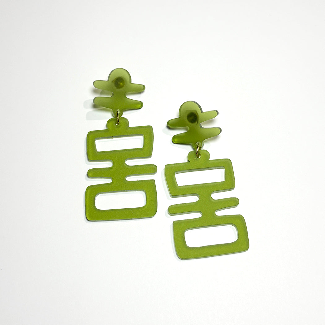 Tiki style Jade Idol statement earrings on a white background. 