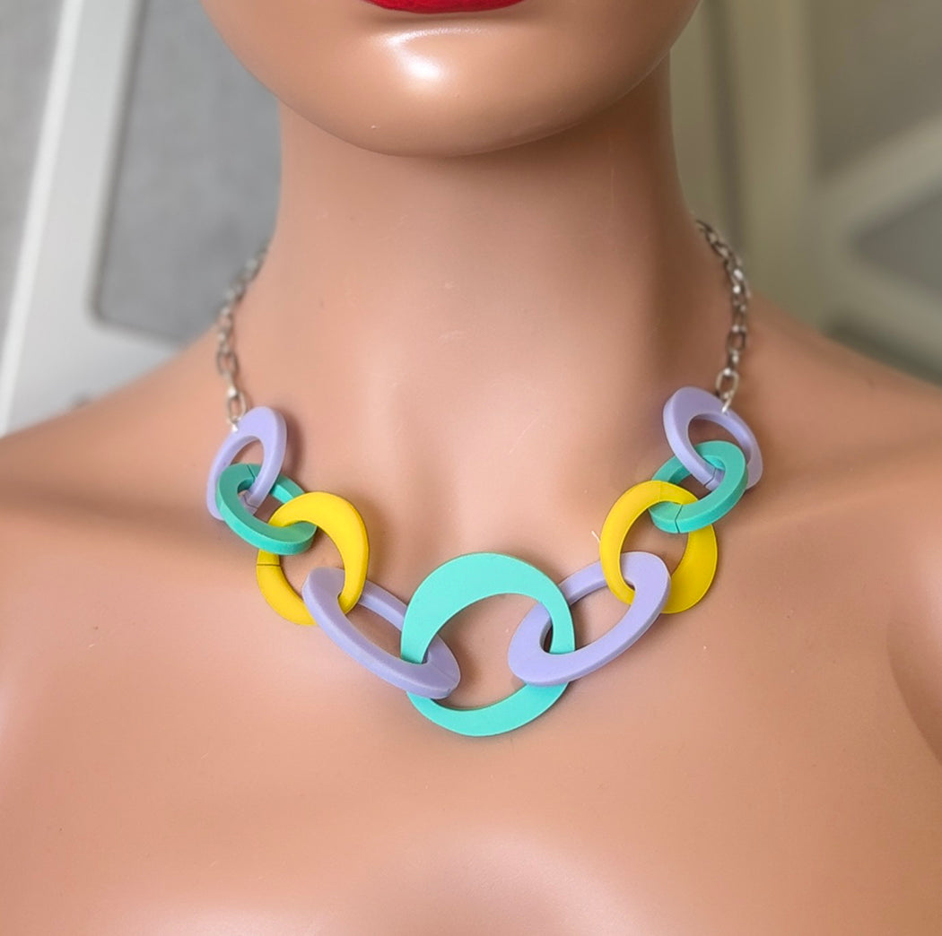 Colorful necklace on a mannequin with a neutral background