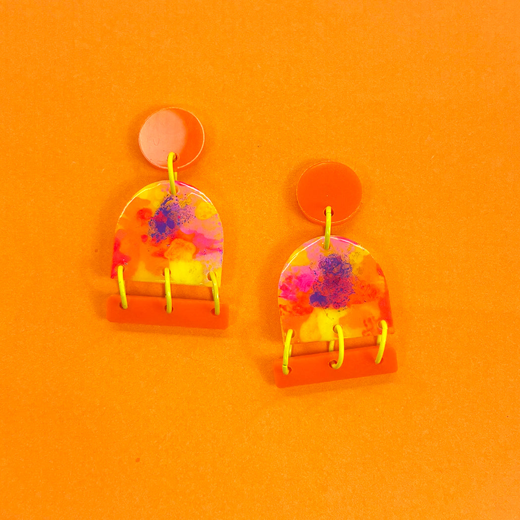 Vibrant hand painted Neon Impressionist post earrings on orange background from Audacious Studio