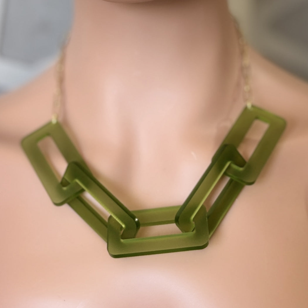 Green chain necklace on a mannequin