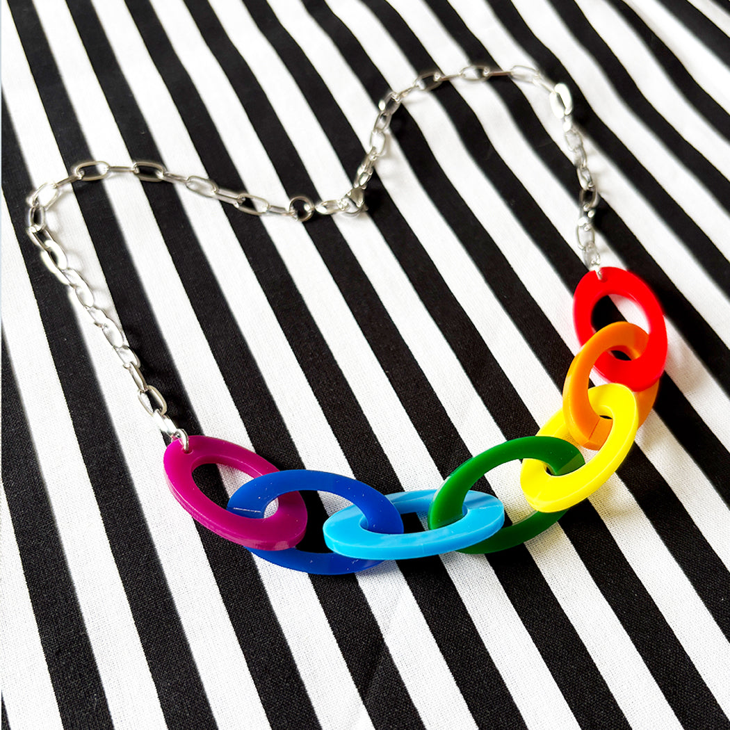Colorful Rainbow chain necklace on a black and white striped background