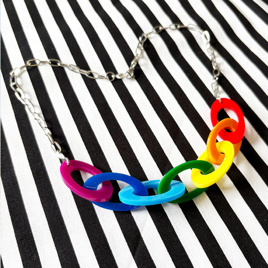 Colorful Rainbow chain necklace on a black and white striped background