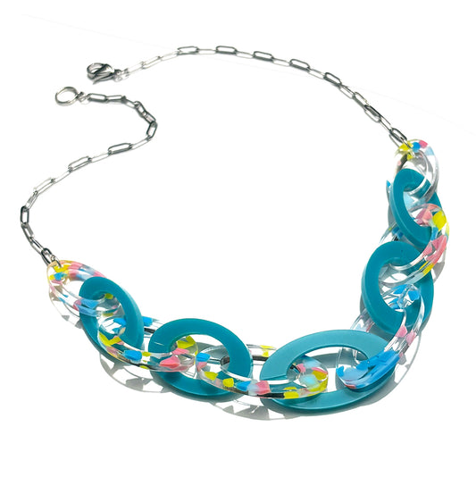 Necklace with blue and clear links on a white background
