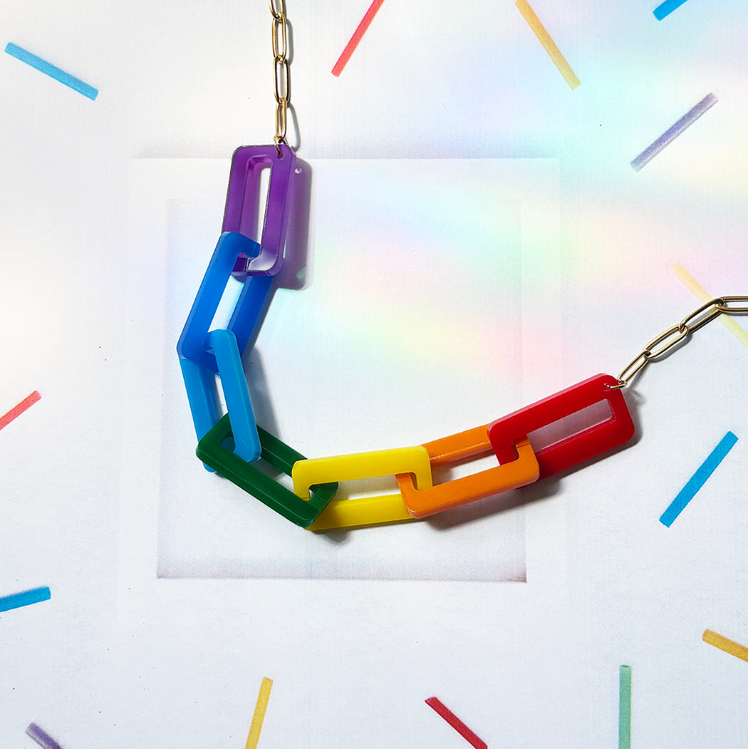 Colorful chain necklace on a white background with colorful lines.