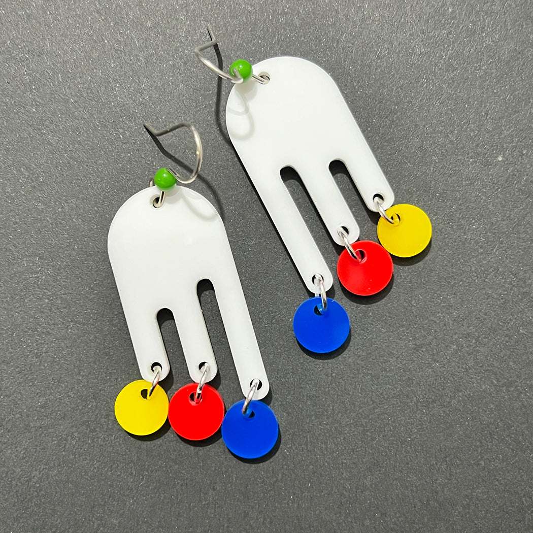 Close up of 30s inspired Nora Drip Mobile earrings in white, red, yellow and blue.