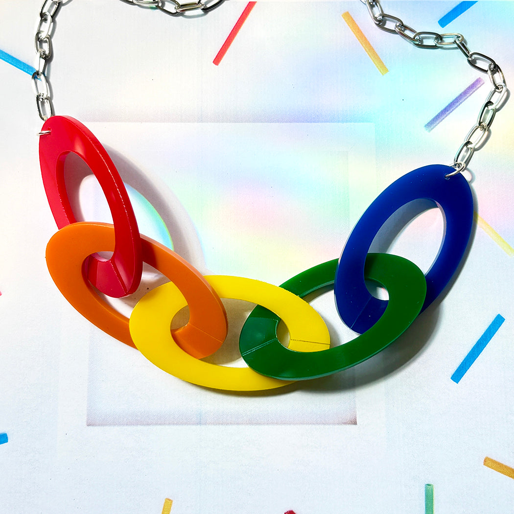Colorful necklace with interlocking rings on a multicolored background