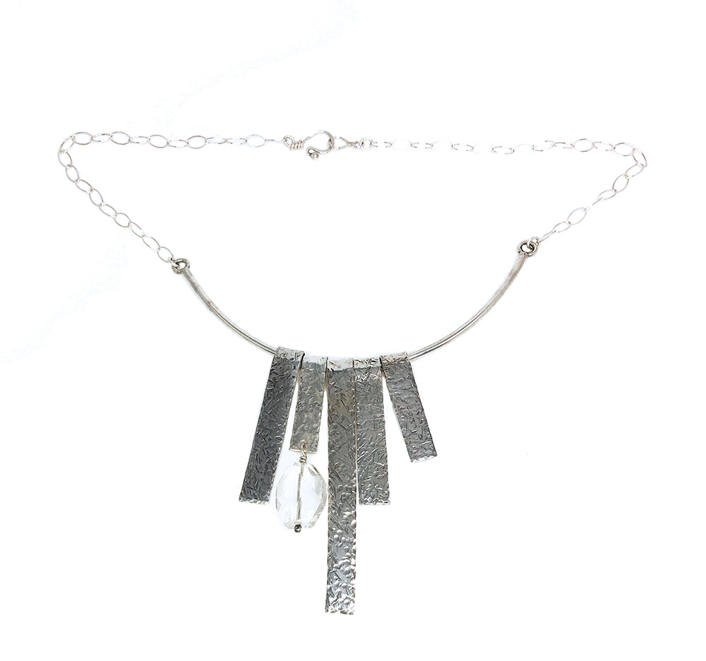 Large sterling bar fringe necklace accented with a quartz stone on a white background.
