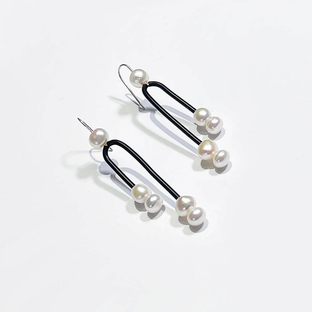 Postmodern Pearl mobile earrings with freshwater pearls and black rubber earrings by Barbe Saint John